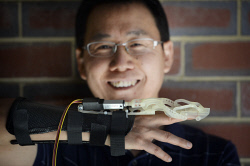 WAN-0019897 © WestPix Dr Lei Cui holding his 3D printable robotic hand exoskeleton. - WAN-0019897_T